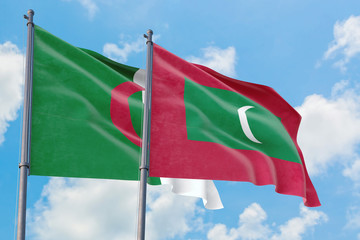 Maldives and Algeria flags waving in the wind against white cloudy blue sky together. Diplomacy concept, international relations.