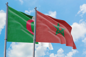 Morocco and Algeria flags waving in the wind against white cloudy blue sky together. Diplomacy concept, international relations.