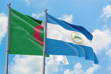 Nicaragua and Algeria flags waving in the wind against white cloudy blue sky together. Diplomacy concept, international relations.
