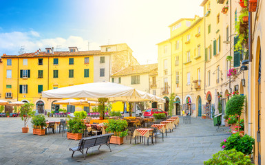 Cafe in the cozy morning lighted square of the old European city.