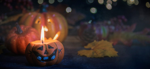 Halloween pumpkin smile and scary eyes for party night. Close up view of scary Halloween pumpkin with eyes glowing inside at black background. Selective focus