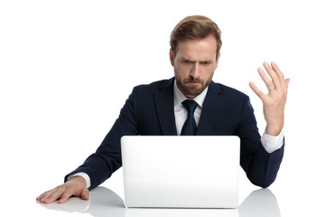 mad businessman in navy blue suit reading emails