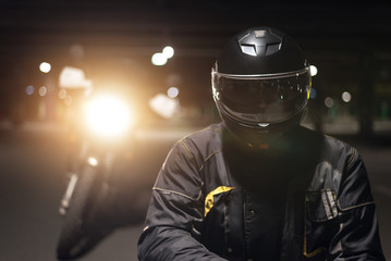 Biker in black helmet close up portrait.