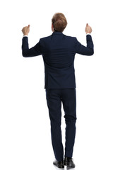 businessman in navy blue suit making thumbs up sign