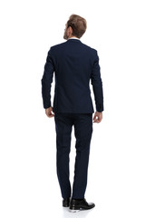 young businessman in navy blue suit looking up and dreaming