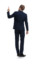 young businessman in navy blue suit pointing finger