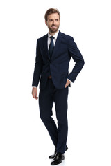 happy young businessman in navy blue suit smiling