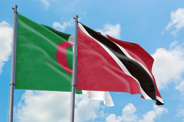 Trinidad And Tobago and Algeria flags waving in the wind against white cloudy blue sky together. Diplomacy concept, international relations.