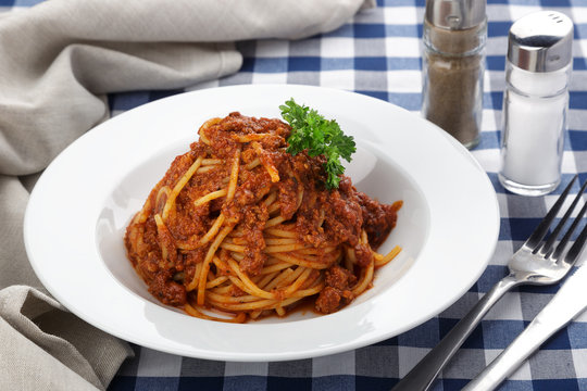 Traditional italian pasta. Pasta with bolognese sauce on a table. Homemade delicious italian traditional pasta on wooden table for dinner. italian cuisine.