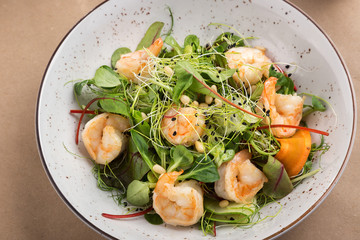 Shrimp salad, lettuce, cucumber, spinach olive oil. fresh healthy shrimps salad. Close up view on Salad. Healthy, diet tasty summer dish