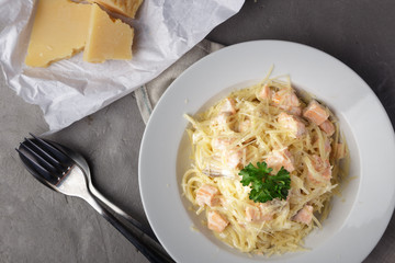 Traditional italian pasta. Spaghetti with salmon, cream cheese on a table. Homemade delicious italian traditional pasta on wooden table for dinner. italian cuisine.