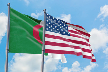 United States and Algeria flags waving in the wind against white cloudy blue sky together. Diplomacy concept, international relations.