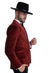sexy young man in red velvet tuxedo wearing hat