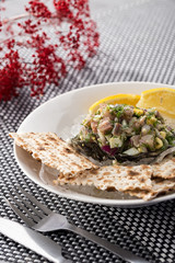 Fine dining appetizer, fish tartare. Tartare with butter and bread. On a wooden table