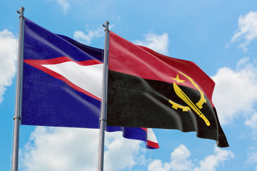 Angola and American Samoa flags waving in the wind against white cloudy blue sky together....