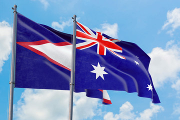 Australia and American Samoa flags waving in the wind against white cloudy blue sky together. Diplomacy concept, international relations.