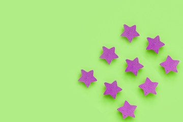 Pink stars on light green background, place for text. pink cookies. Copy space. Mock up
