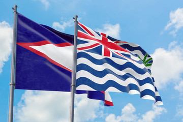 British Indian Ocean Territory and American Samoa flags waving in the wind against white cloudy blue sky together. Diplomacy concept, international relations.