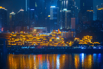 City night view of Chongqing, China.  The scenery by the river.  The fusion of modern architecture and folk architecture.  City view by the water