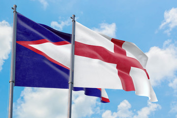 England and American Samoa flags waving in the wind against white cloudy blue sky together. Diplomacy concept, international relations.