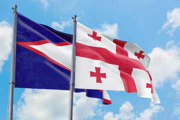 Georgia and American Samoa flags waving in the wind against white cloudy blue sky together. Diplomacy concept, international relations.