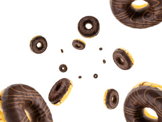 Bakery cake. Glazed fresh chocolate cookies falling on white background.