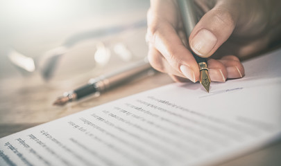 Business woman signing contract, making a deal.