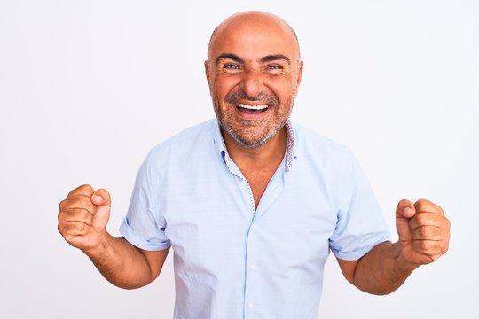 Middle age handsome man wearing casual shirt standing over isolated white background with a happy and cool smile on face. Lucky person.