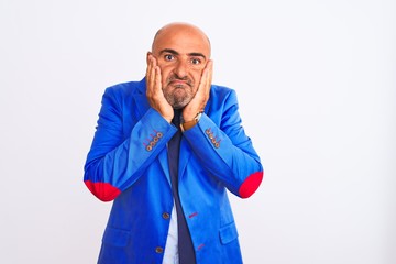 Middle age businessman wearing suit standing over isolated white background worried and stressed about a problem with hand on forehead, nervous and anxious for crisis