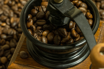 coffee grinder and beans on wooden table