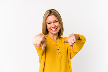 Young blonde caucasian woman isolated cheerful smiles pointing to front.