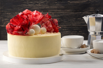 Delicious festive homemade cake. Red velvet cake. Delicious festive homemade cake. Delicious homemade cake with sugar flowers. cake on a white plate. Close up view. Space for text