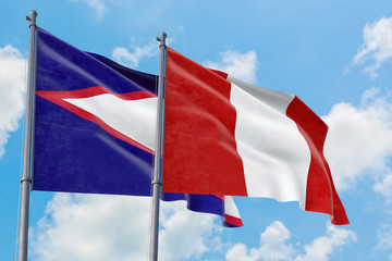 Peru and American Samoa flags waving in the wind against white cloudy blue sky together. Diplomacy concept, international relations.