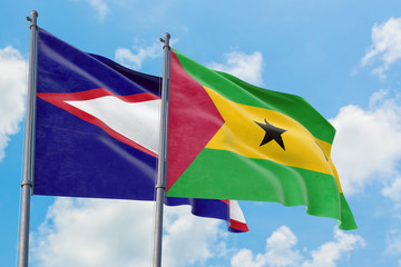 Sao Tome And Principe and American Samoa flags waving in the wind against white cloudy blue sky together. Diplomacy concept, international relations.