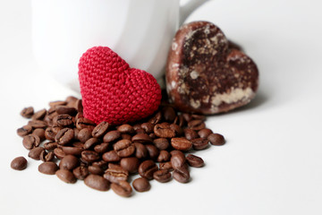 Valentine heart, gingerbread and cup of coffee with roasted beans on white background. Romantic breakfast, concept of love and care, morning dessert