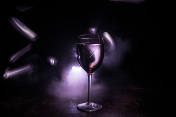 Goblet of white wine on wooden table on wooden wall background