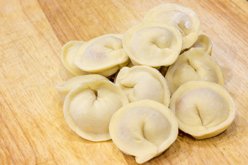 Traditional Russian dumplings hand-made on a cutting Board.