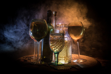 Goblet of white wine on wooden table on wooden wall background