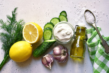 Ingredients for making traditional greek sauce tzatziki. Top view with copy space.
