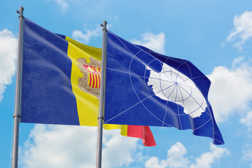 Antarctica and Andorra flags waving in the wind against white cloudy blue sky together. Diplomacy concept, international relations.