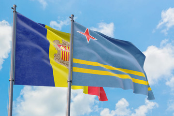 Aruba and Andorra flags waving in the wind against white cloudy blue sky together. Diplomacy concept, international relations.