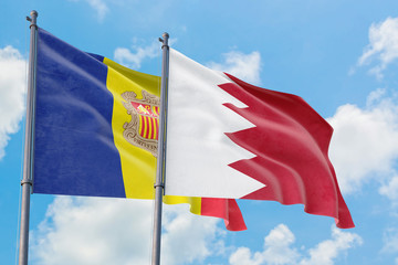 Bahrain and Andorra flags waving in the wind against white cloudy blue sky together. Diplomacy concept, international relations.
