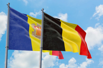 Belgium and Andorra flags waving in the wind against white cloudy blue sky together. Diplomacy concept, international relations.