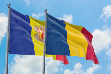 Chad and Andorra flags waving in the wind against white cloudy blue sky together. Diplomacy concept, international relations.