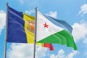 Djibouti and Andorra flags waving in the wind against white cloudy blue sky together. Diplomacy concept, international relations.