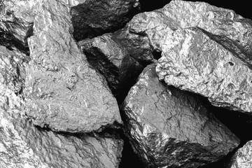Manganese, manganese, or magnesium stone is a chemical element, it is in the manufacture of metal alloys. Silver colored ore, industrial use. Ore on black isolated background.
