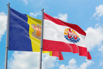 French Polynesia and Andorra flags waving in the wind against white cloudy blue sky together. Diplomacy concept, international relations.