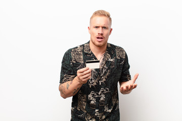 young blonde man looking angry, annoyed and frustrated screaming wtf or what‚Äôs wrong with you...