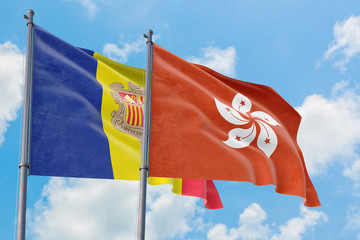 Hong Kong and Andorra flags waving in the wind against white cloudy blue sky together. Diplomacy concept, international relations.