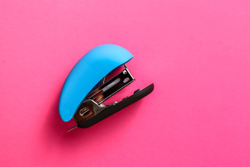 Office stapler on color background